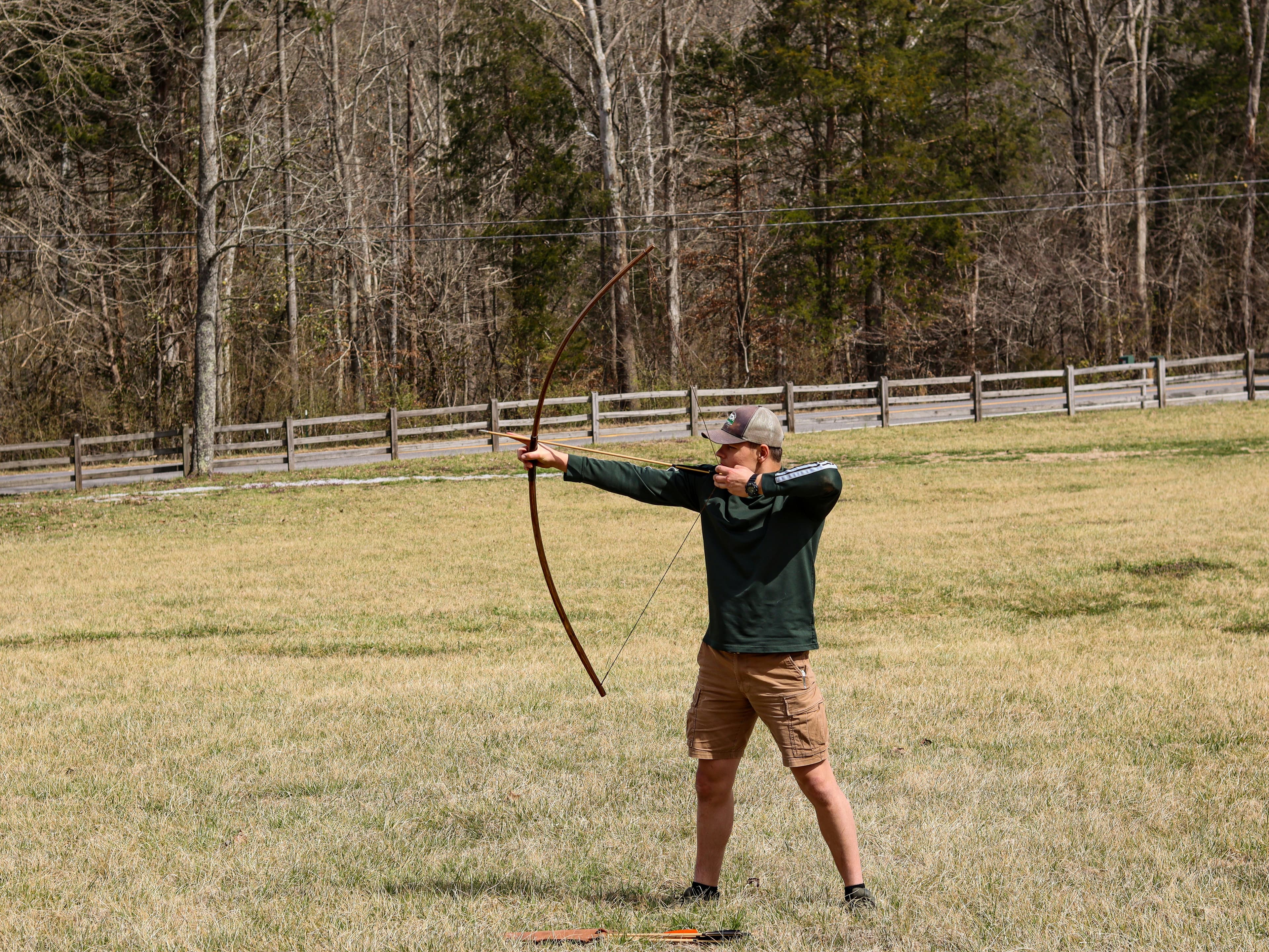 Person doing archery at camp